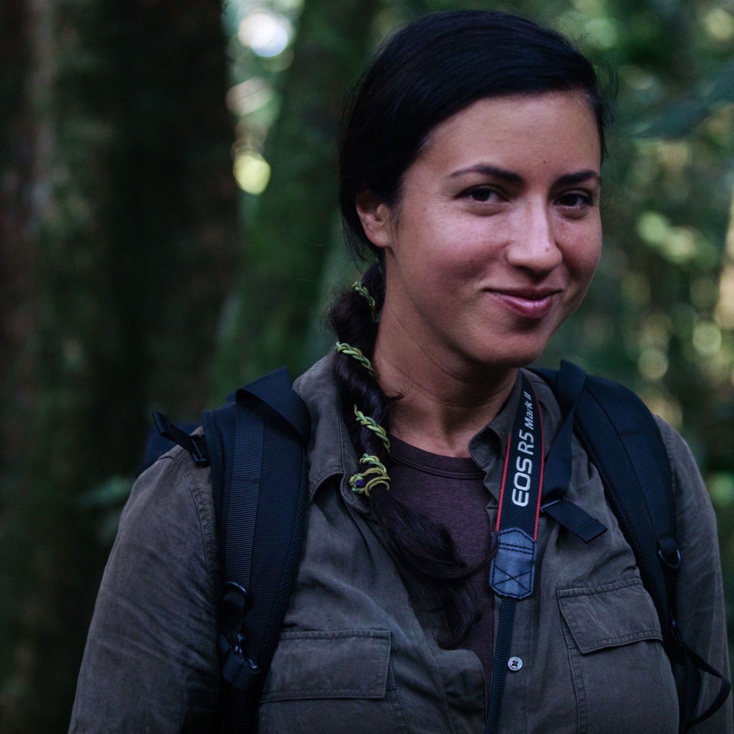 Woman in jungle wearing camo hair tie accessory