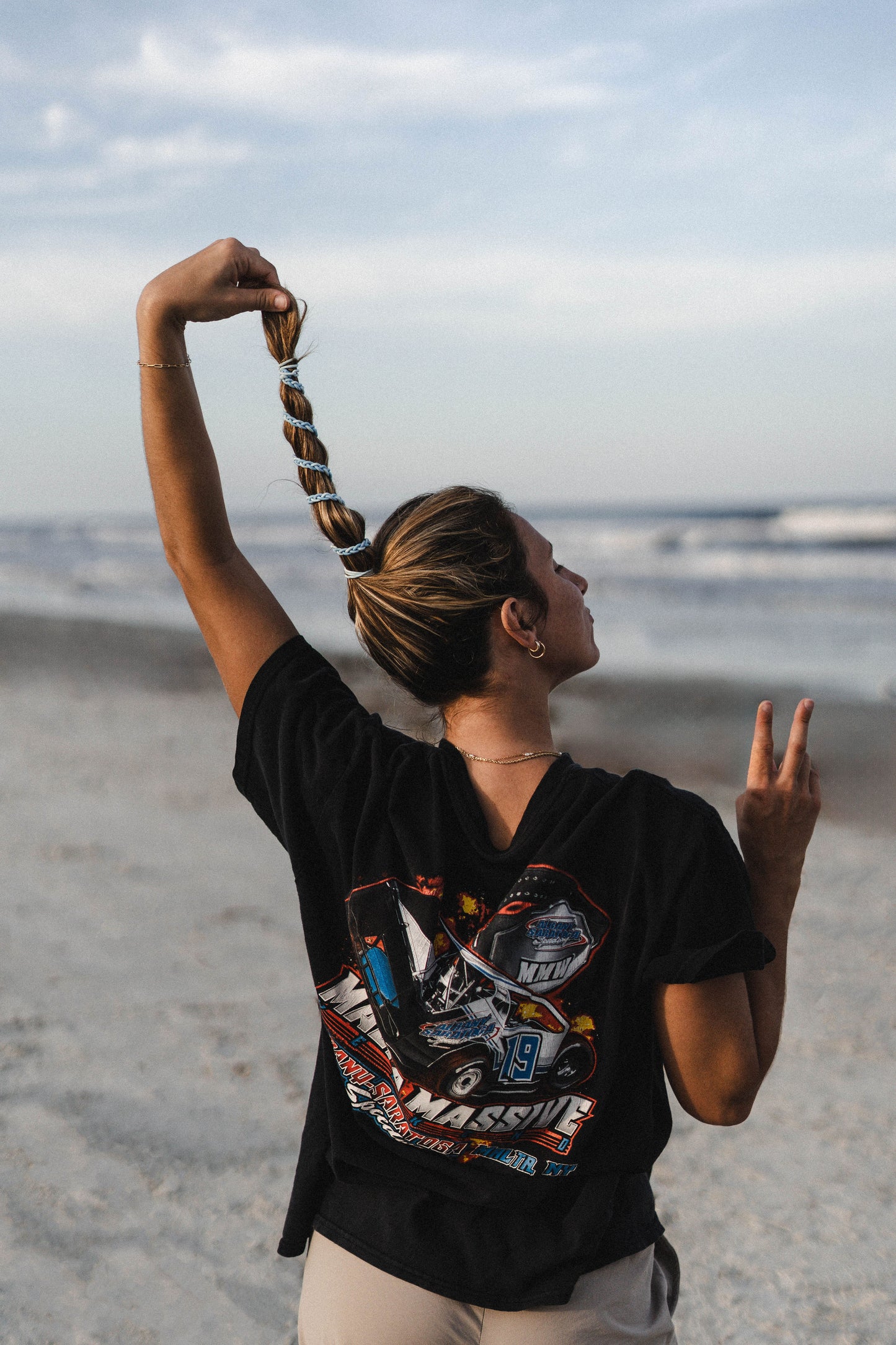 woman on beach with pastel blue wraparound hair tie in hair