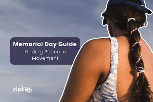 Woman pausing in quiet reflection outdoors on Memorial Day, hair secured with a Freedom Trail Rip Tie hair tie.