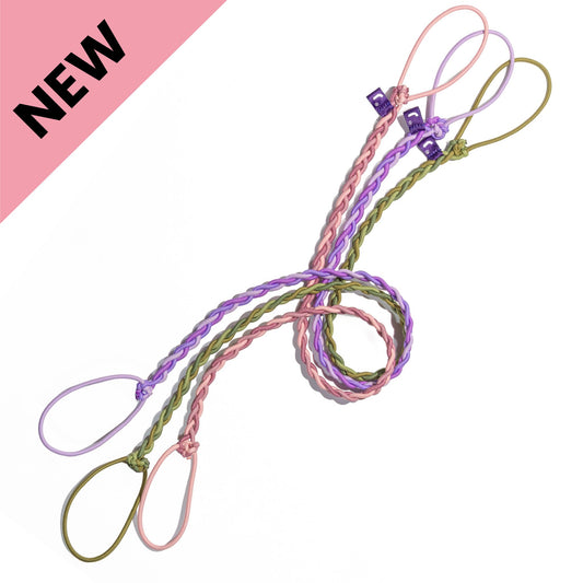 Set of three Rip Tie hair bands in Painted Dunes purple, Canyon Sunrise pink, and Basecamp camo green on a white background – the best hair ties for active lifestyles.