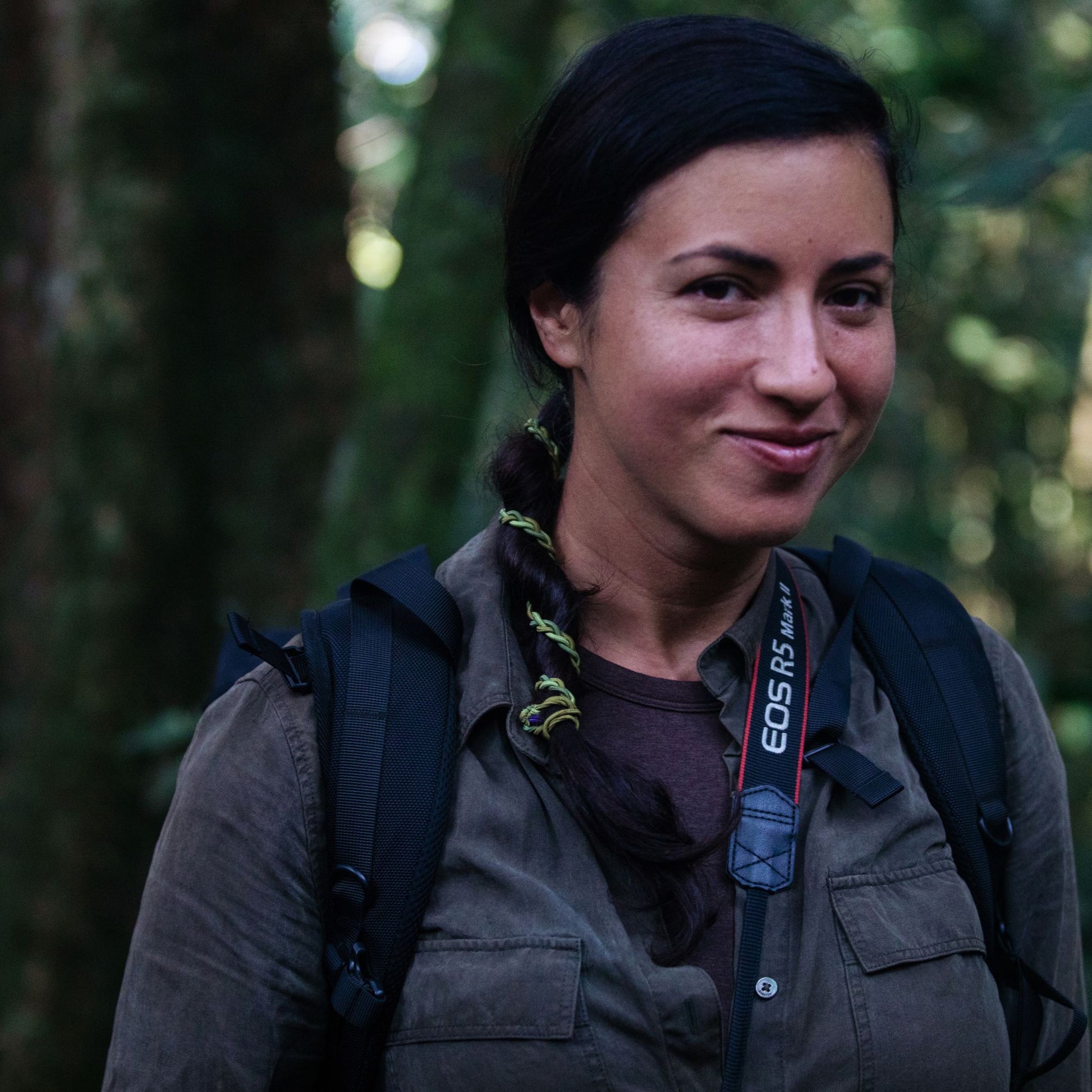 Woman in jungle wearing camo hair tie accessory