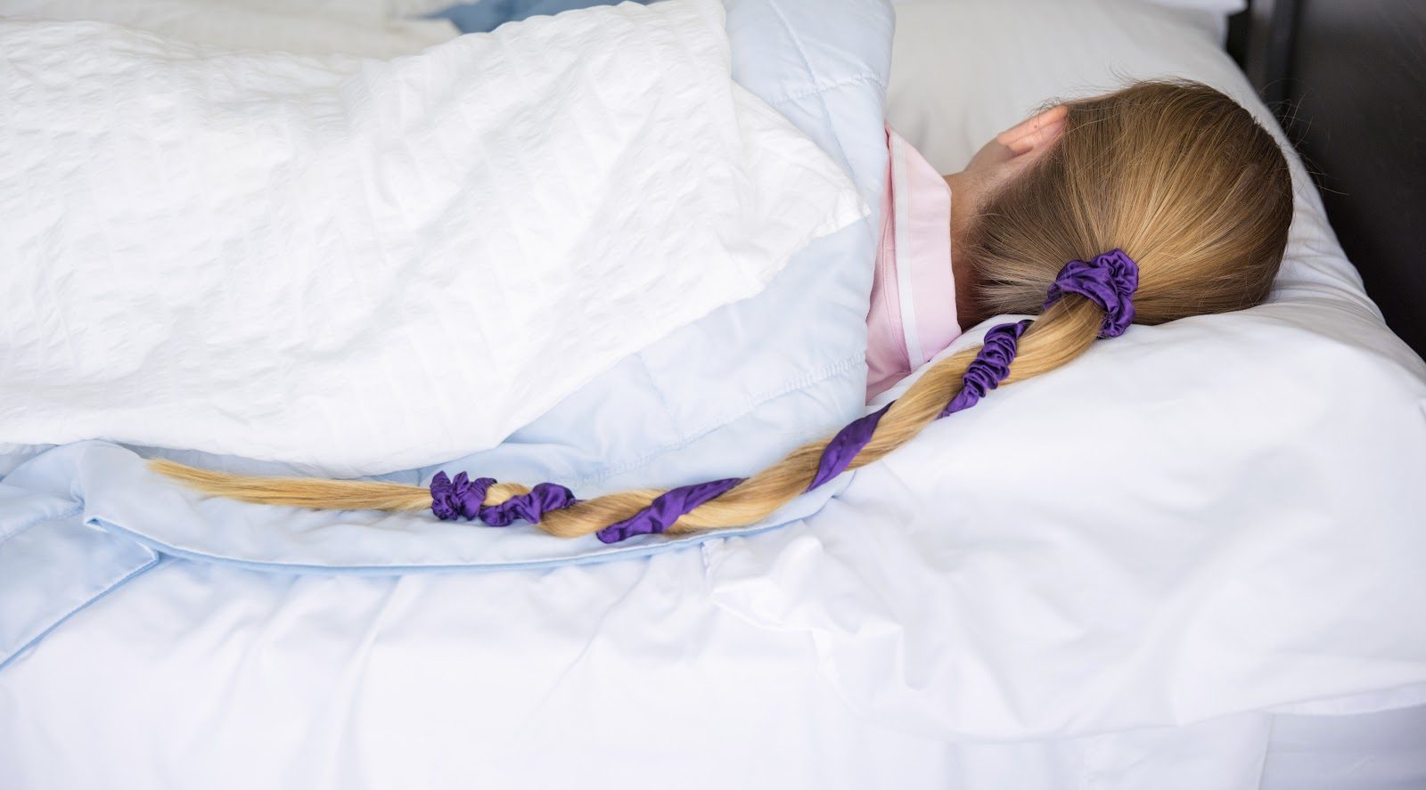 Asleep with long hair kept tangle-free in a Midnight Haze Slumber tie
